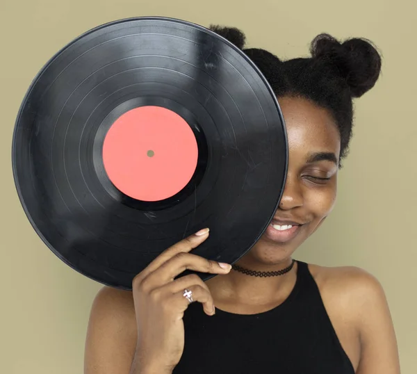 Woman covering face by vinyl record — Stock Photo, Image