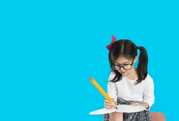 Girl writing with big pencil — Stock Photo, Image