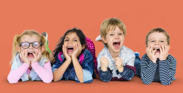 Multi ethnic children laying on floor — Stock Photo, Image