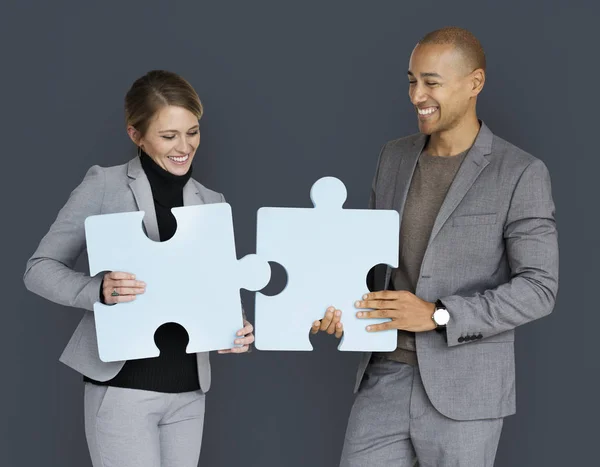 Business People Holding Jigsaw Puzzle