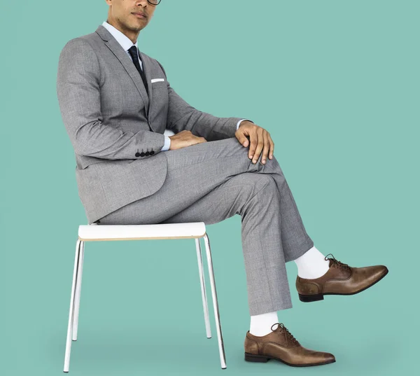 Mixed race Businessman sitting on chair — Stock Photo, Image