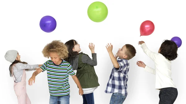 Παιδιά που παίζουν με πολύχρωμα μπαλόνια — Φωτογραφία Αρχείου