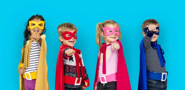 Dzieci w superbohatera kostiumy wskazując palcami — Zdjęcie stockowe