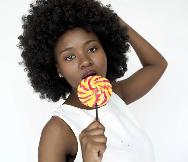 Mujer con peinado afro comer dulces —  Fotos de Stock