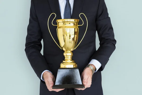 Homem de negócios segurando troféu — Fotografia de Stock