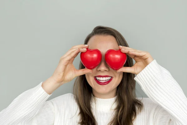 Mujer sosteniendo corazones rojos — Foto de Stock