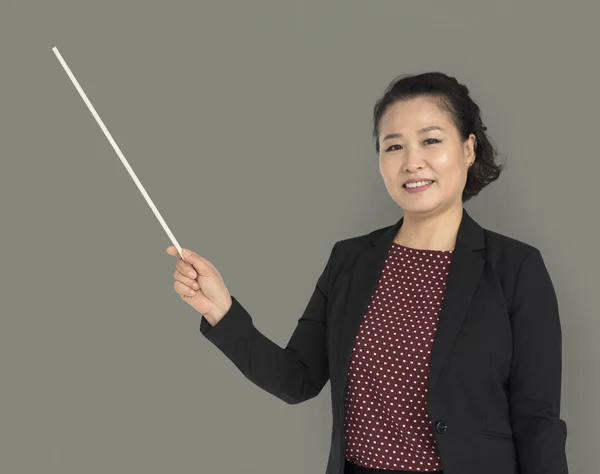 Businesswoman holding pointer Stock Image