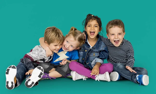 Happy children sitting on floor — Stock Photo, Image