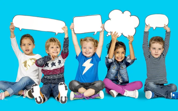 Niños sosteniendo burbujas del habla —  Fotos de Stock