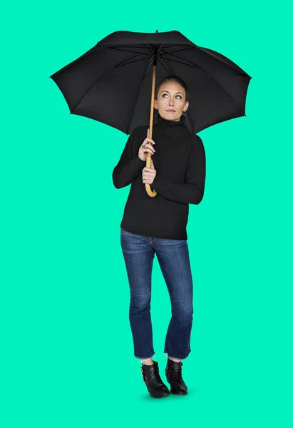 Woman holding umbrella in studio — Stock Photo, Image