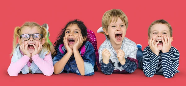 Multi ethnic children laying on floor — Stock Photo, Image