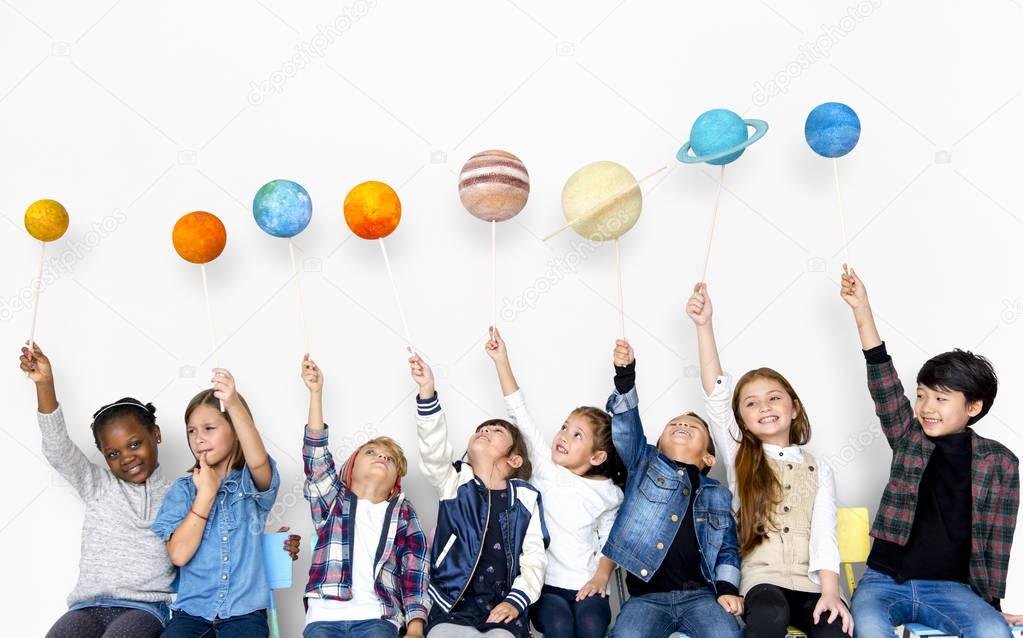 children Holding solar system