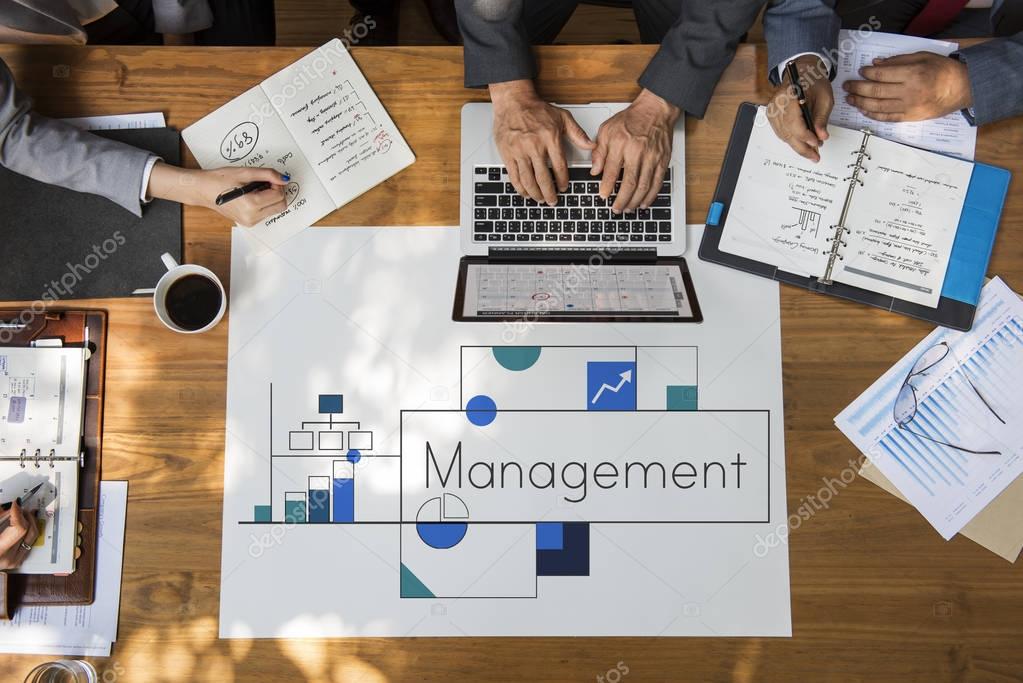 Hands of businesspeople over wooden table and banner with Management concept