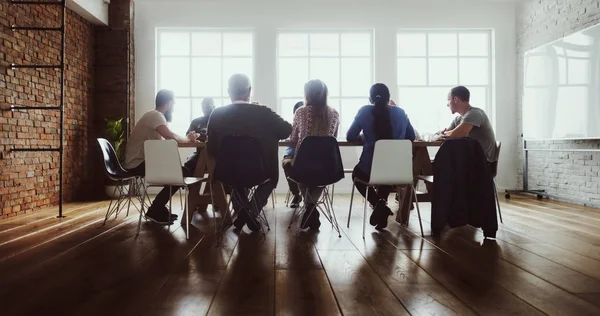 Ludzie siedzący przy stole na spotkanie biznesowe — Zdjęcie stockowe