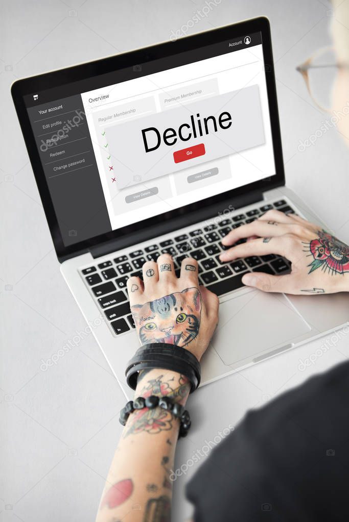woman with tattoos on hands using laptop and typing on keyboard, text: Decline