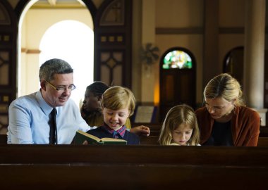 Family praying in the Church clipart