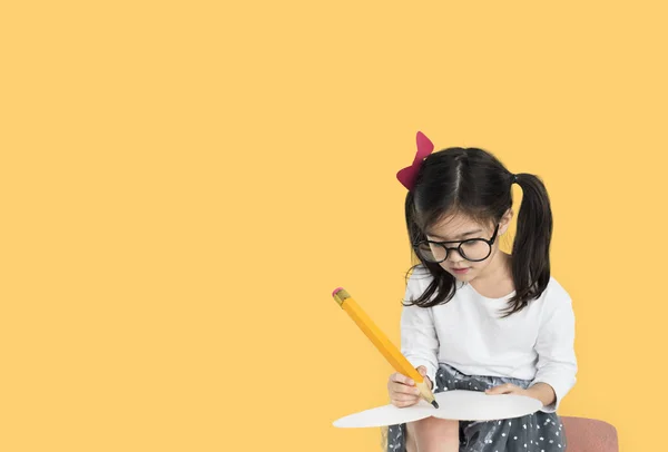 Girl writing with big pencil — Stock Photo, Image