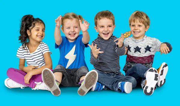 Happy children sitting on floor — Stock Photo, Image