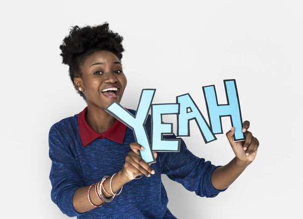 african woman holding YEAH letters