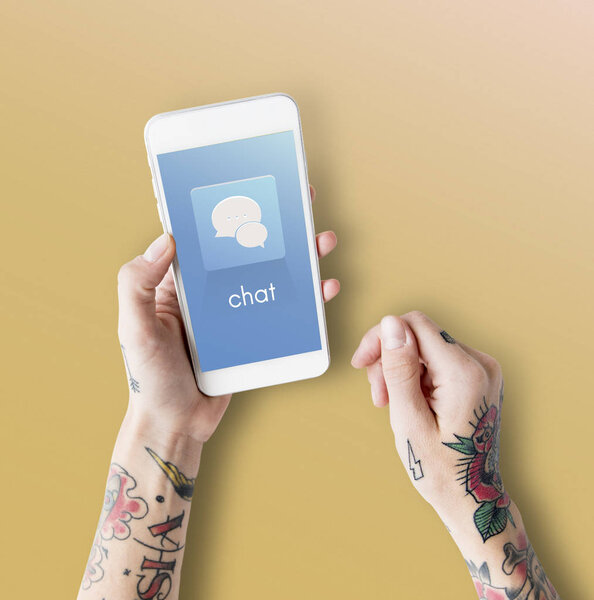 Tattooed woman hands with smartphone