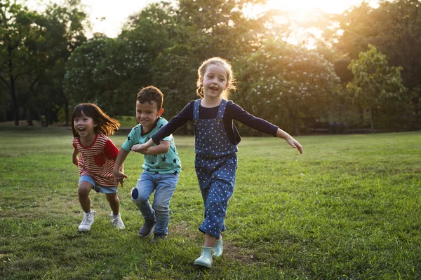 Children running in field — Stock Photo, Image