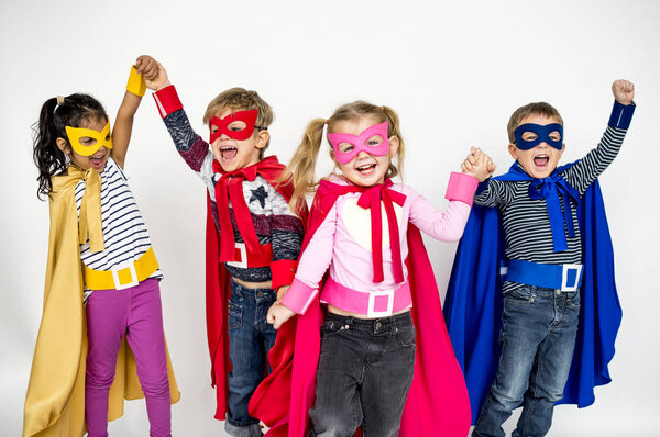 happy children in Superhero costumes