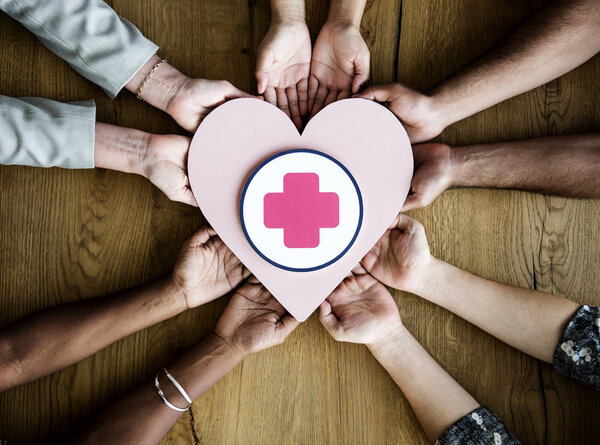 Hands holding pink heart — Stock Photo, Image