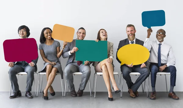 Business people holding speech bubbles — Stock Photo, Image