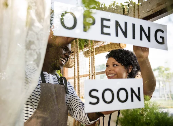 Couple Showing Opening Soon Sign — Stock Photo, Image