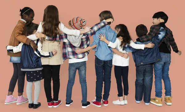 Diversity children hugging in studio — Stock Photo, Image