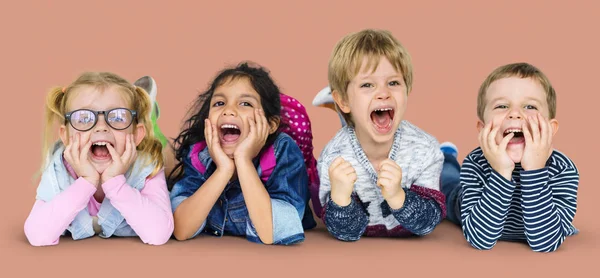 Multi ethnic children laying on floor — Stock Photo, Image