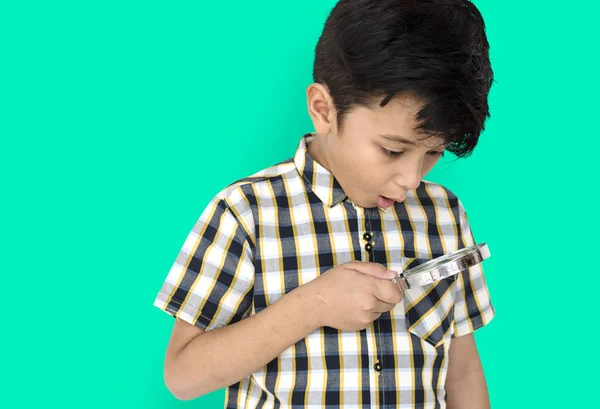 Boy looking in magnifying glass — Stock Photo, Image