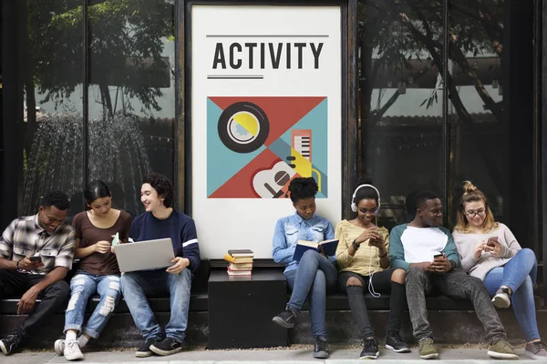 Young students siting near placard — Stock Photo, Image