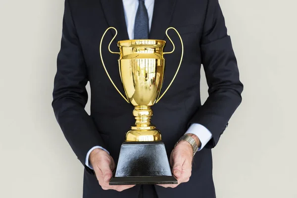 Biznesmen gospodarstwa złote trofeum — Zdjęcie stockowe
