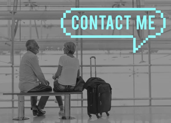 Senior couple sitting on bench in airport — Stock Photo, Image