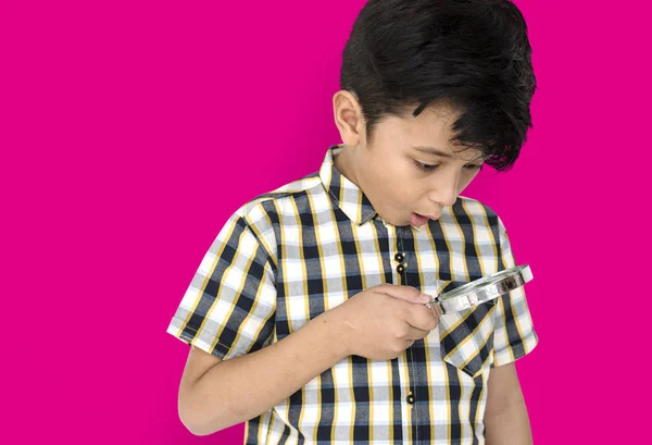 Boy looking in magnifying glass — Stock Photo, Image