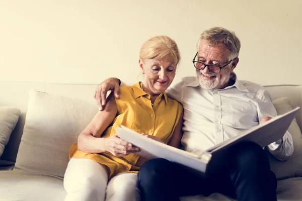 Couple Looking at Photo Album — Stock Photo, Image