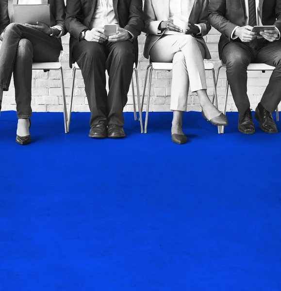 Business people sitting on chairs