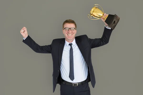 business man holding golden trophy