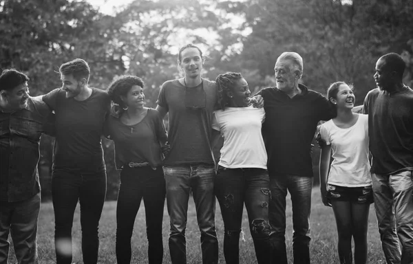 people huddle and smiling together