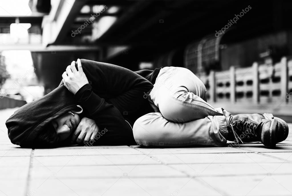 homeless man sleeping on street