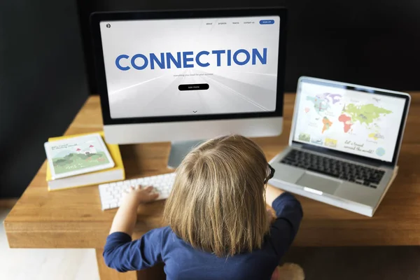 Little girl sitting at workplace table — Stock Photo, Image