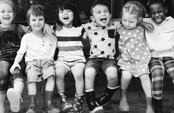 Kindergarten kids sitting and smiling — Stock Photo, Image