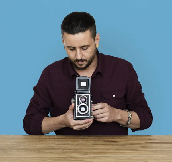 Homem usando câmera enquanto sentado à mesa — Fotografia de Stock