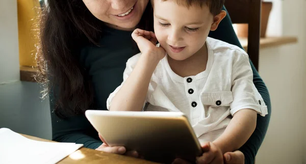 mother and son using tablet