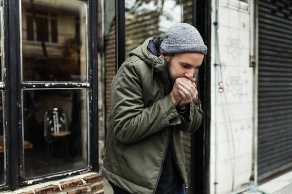 Ragazzo soffiando la sua mani — Foto Stock