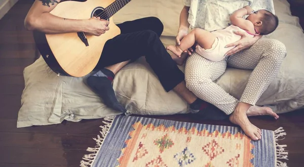 Father and mother taking care of child — Stock Photo, Image