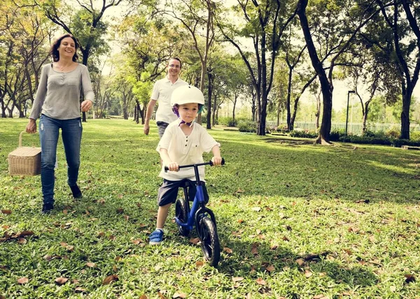 Family cycling in park — Stock Photo, Image