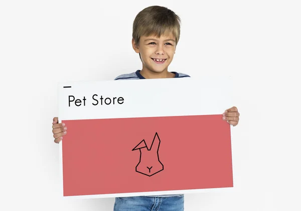 Boy holding placard — Stock Photo, Image