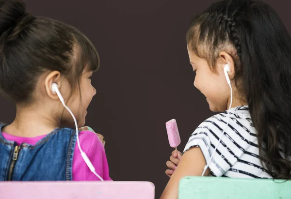 Duas meninas ouvindo música em fones de ouvido — Fotografia de Stock